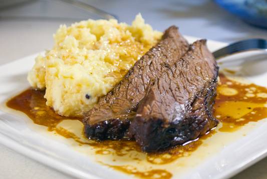 Oven smoked brisket with mashed potatoes and drippings. Yum!