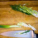 Slice the green onions diagonally Slice the green onions diagonally