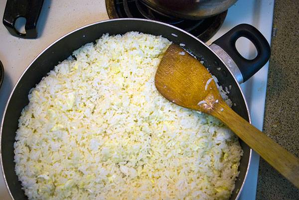 Toss eggs and rice together until every grain is coated. That's the secret to fried rice