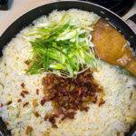 Add the bacon and green onions to the bacon fried rice. Add the bacon and green onions to the bacon fried rice.