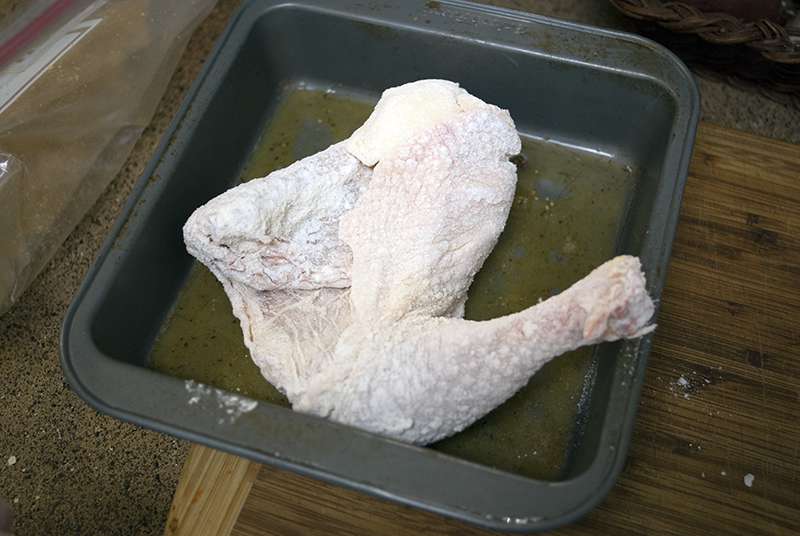 Coating floured chicken pieces in egg for Dritos Crusted Chicken