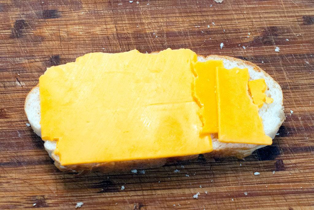 Assembling the Roast Beef Melt Sandwich. First, lay out some cheese