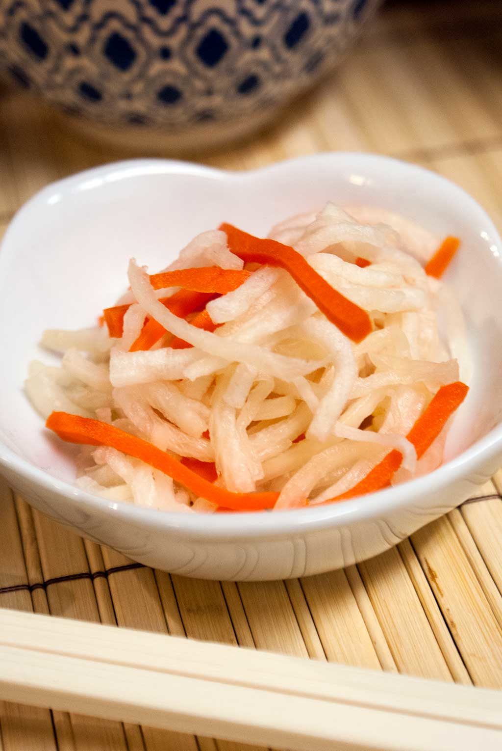 Namasu is a traditional Japanese salad made with daikon radish and carrots marinated in a sweet and tangy dressing
