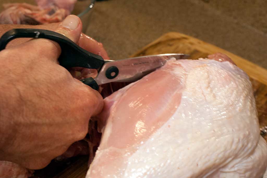 Parting a turkey with kitchen shears - How to butcher a turkey series