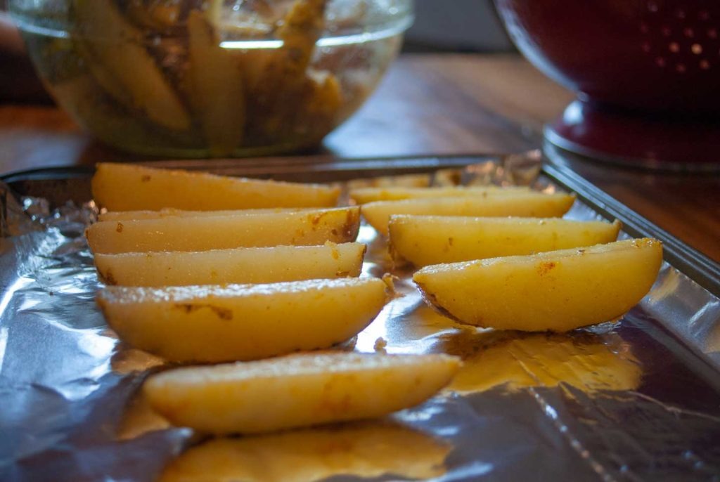 Arrange potato wedges on a foil-lined baking sheet
