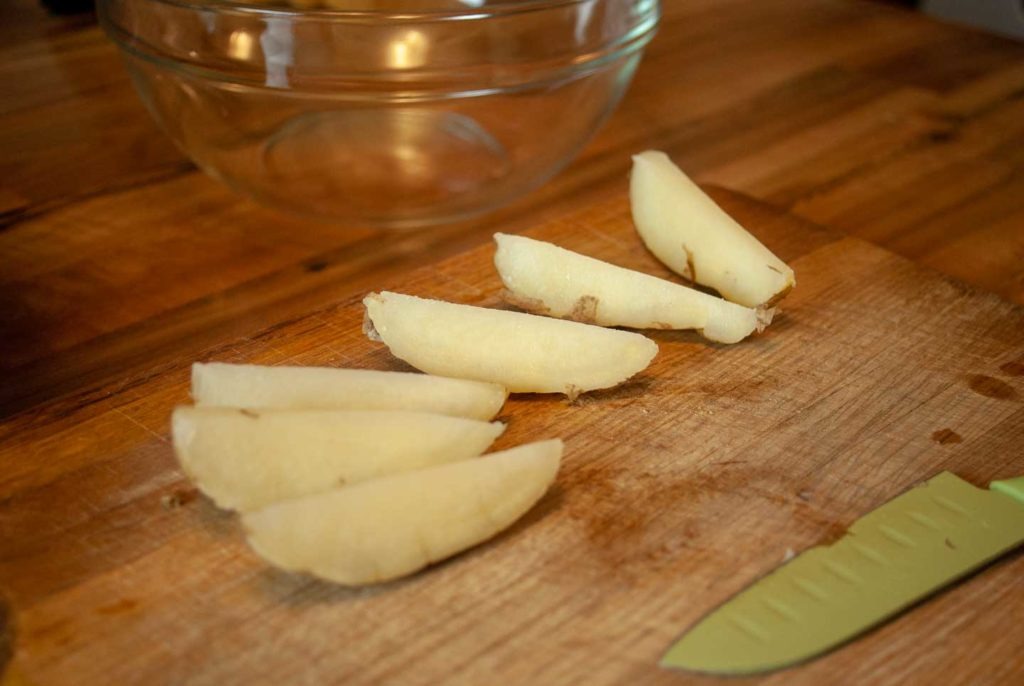 Par boiled potatoes cut into wedges