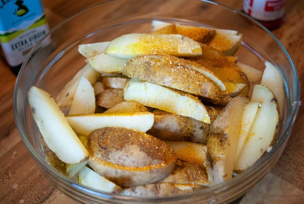 Seasoned potato wedges in bowl