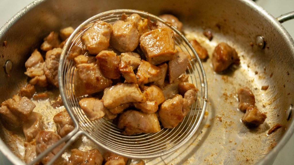 Remove cooked pork from skillet