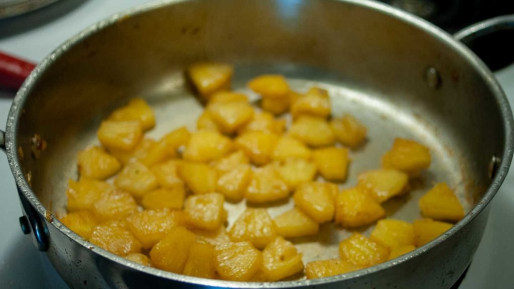 Pineapple caramelizing in a skillet