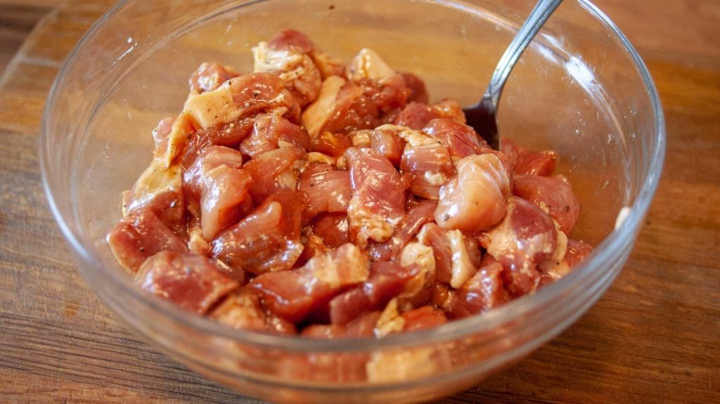 Pork marinating in a bowl