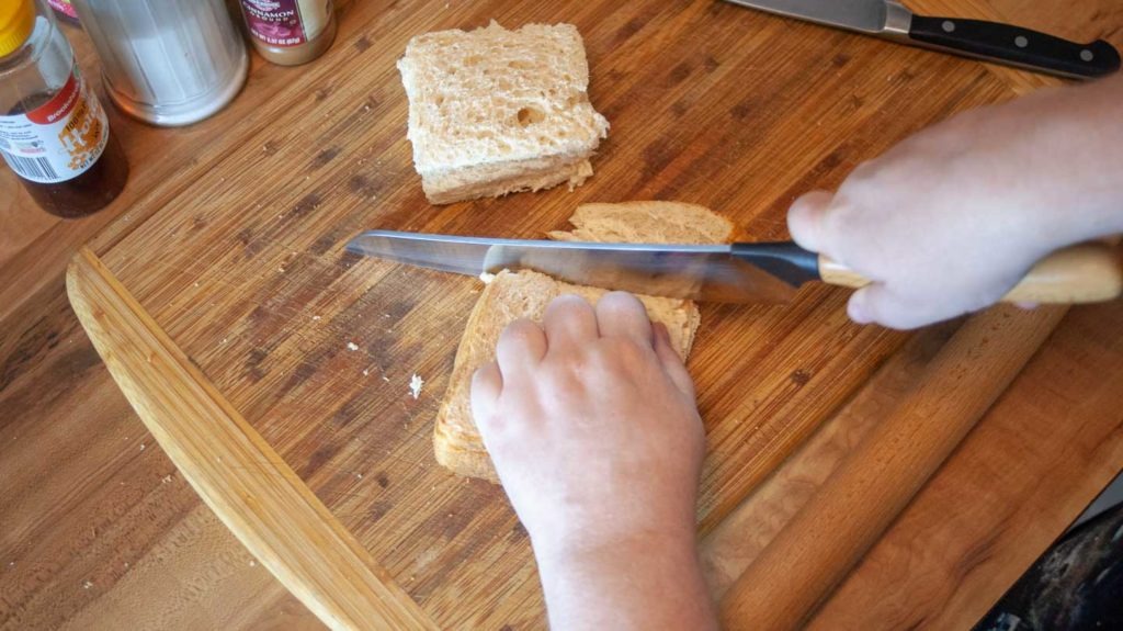 Cutting crusts off of bread slices