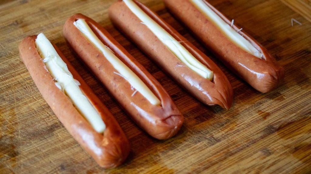 Uncooked sausages stuffed with string cheese