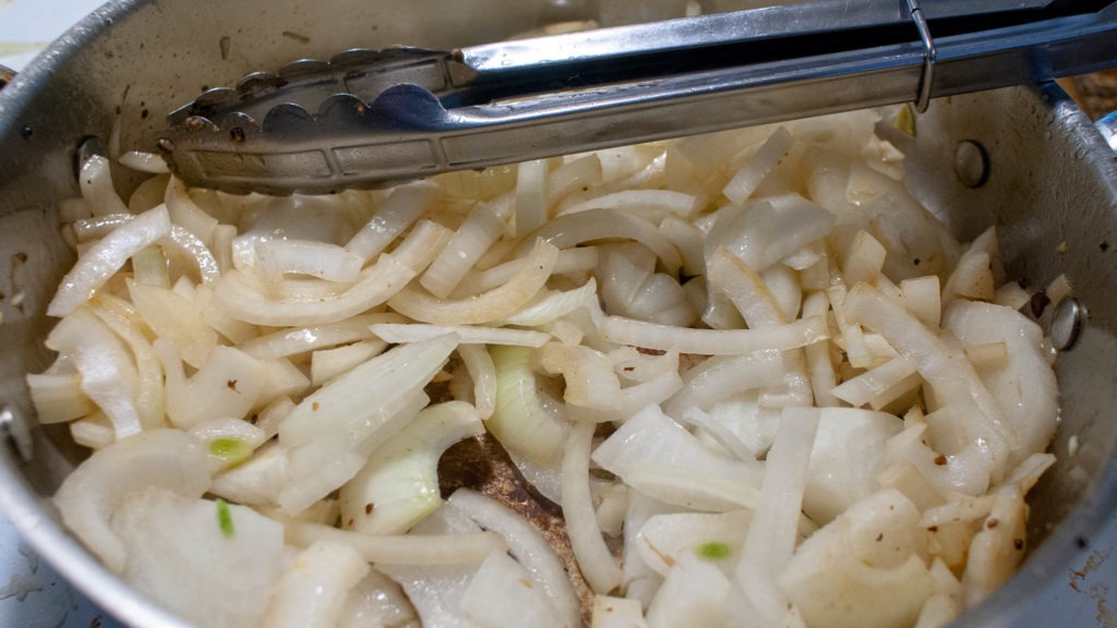 Onions sizzling in a hot pan