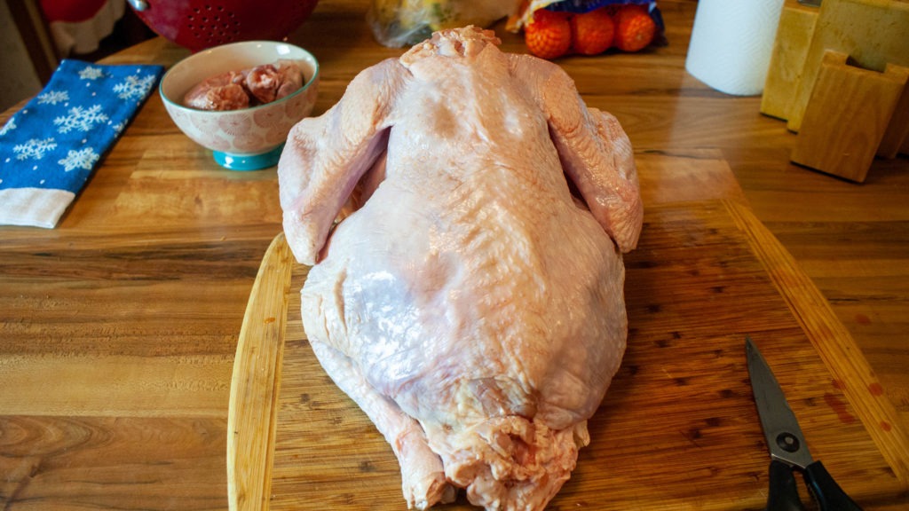 Raw whole turkey on a cutting board