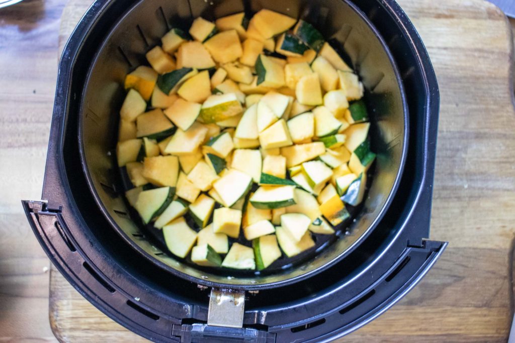 Cubed squash in air fryer basket