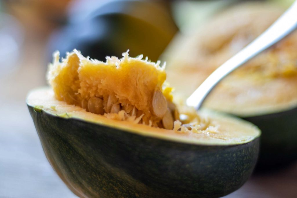 Scooping seeds from an acorn squash