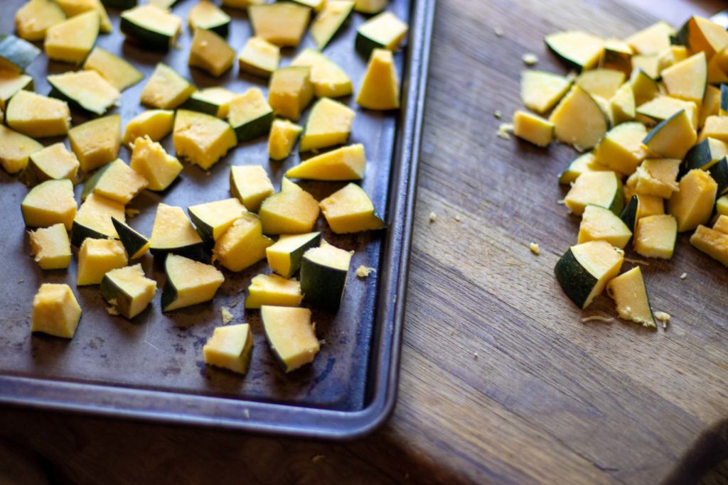 Cubed squash on a baking sheet