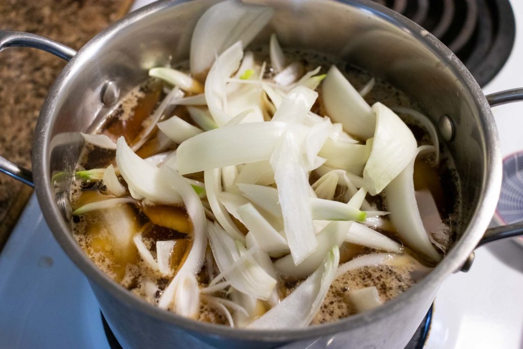 A pot with onions cooking