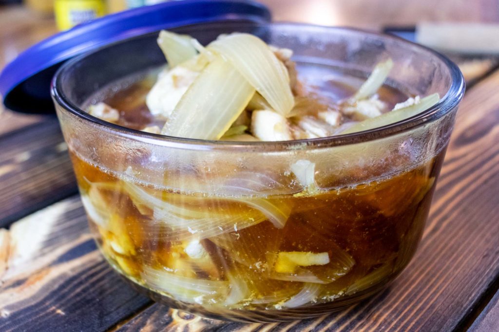 simmered chicken and onions in a storage bowl