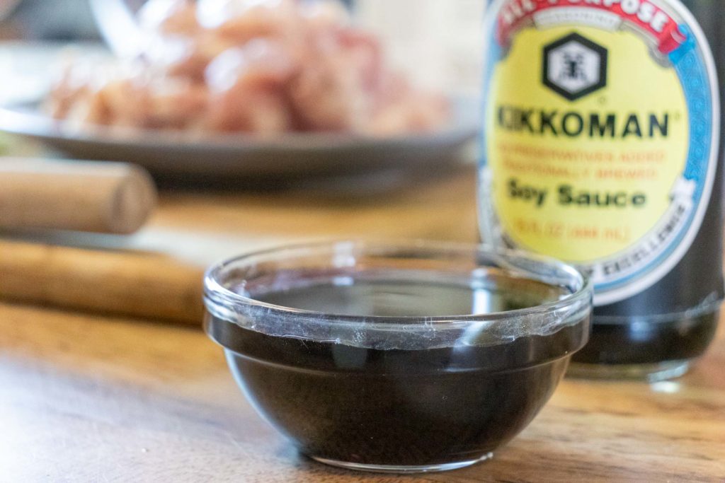 A small glass bowl full of soy sauce